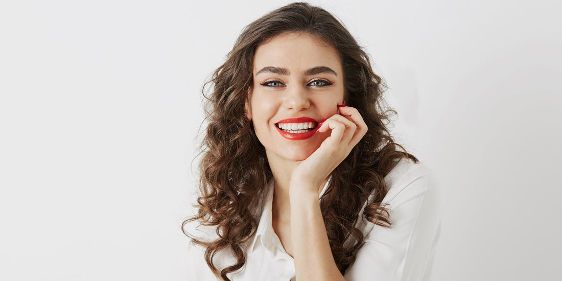 A girl showing her teeth, highlighting that clean teeth are essential for overall oral health, self-confidence, and avoiding dental problems.